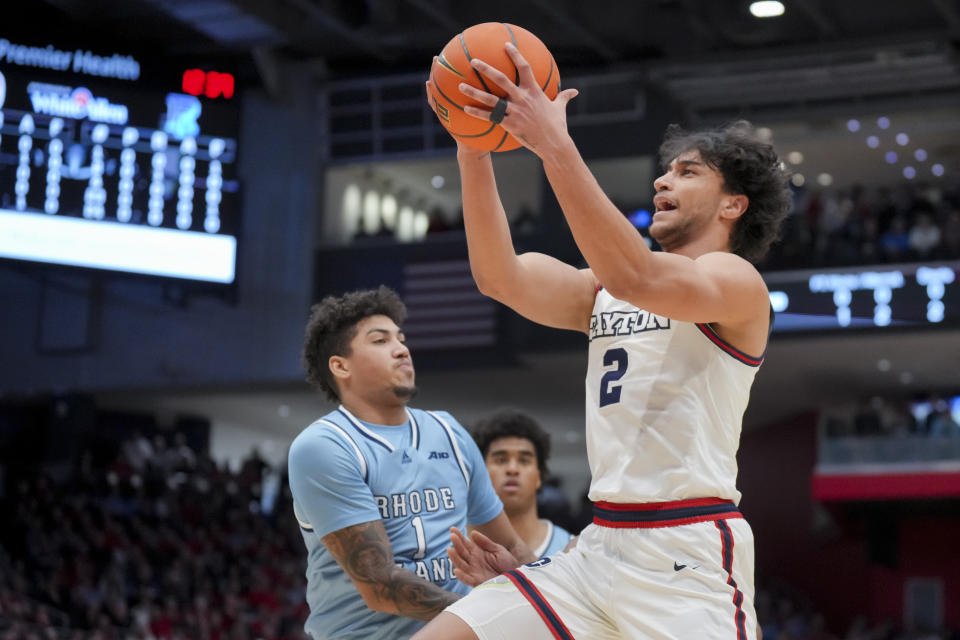 Dayton forward Nate Santos (2) drives to the basket ahead of Rhode Island guard Luis Kortright (1) during the first half of an NCAA college basketball game, Saturday, Jan. 20, 2024, in Dayton, Ohio. (AP Photo/Aaron Doster)
