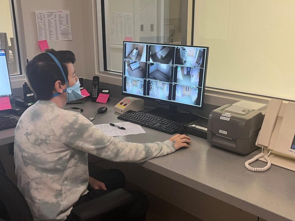 Heather Sondrini, mental health technician at Frisbie Memorial Hospital, uses a monitor to keep an eye on patients in the behavioral health pod in the Frisbie Memorial Hospital Emergency Department to help ensure patient safety.