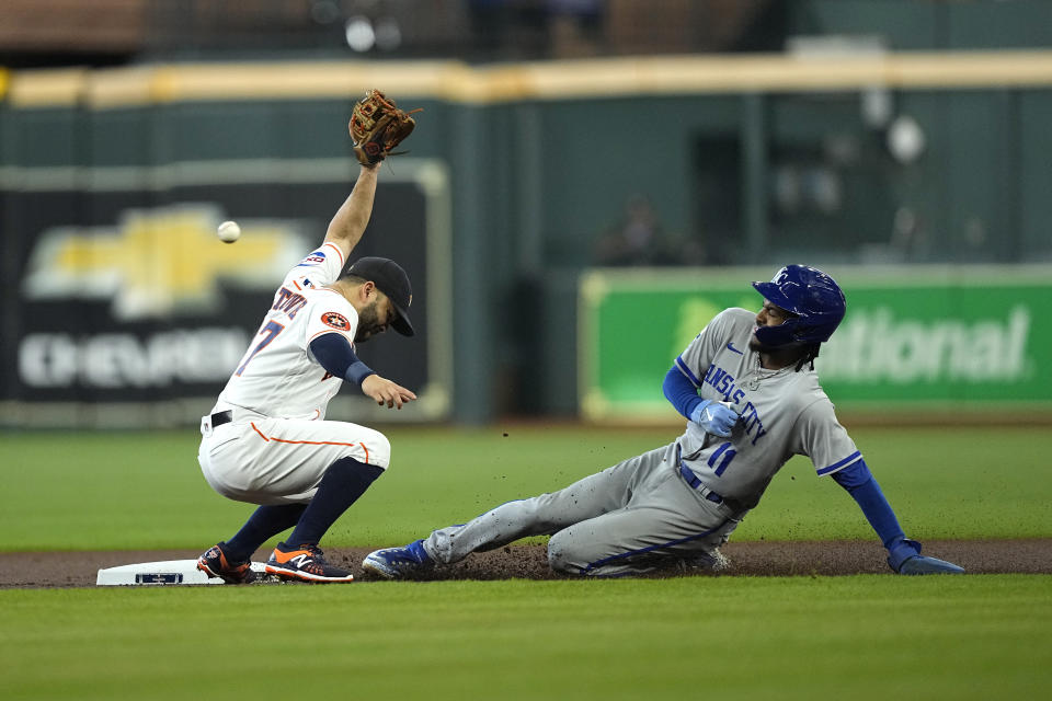 Kansas City Royals' Maikel Garcia (11) steals second base as Houston Astros second baseman Jose Altuve reaches for the throw from catcher Yainer Diaz during the first inning of a baseball game Saturday, Sept. 23, 2023, in Houston. Garcia advanced to third on the throwing error by Diaz. (AP Photo/David J. Phillip)