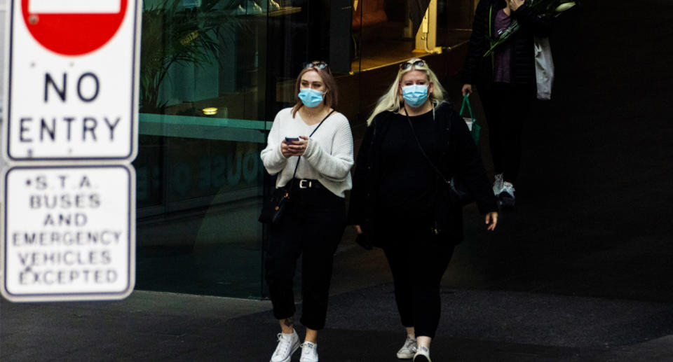 Two women wear face masks in Sydney during the coronavirus pandemic.