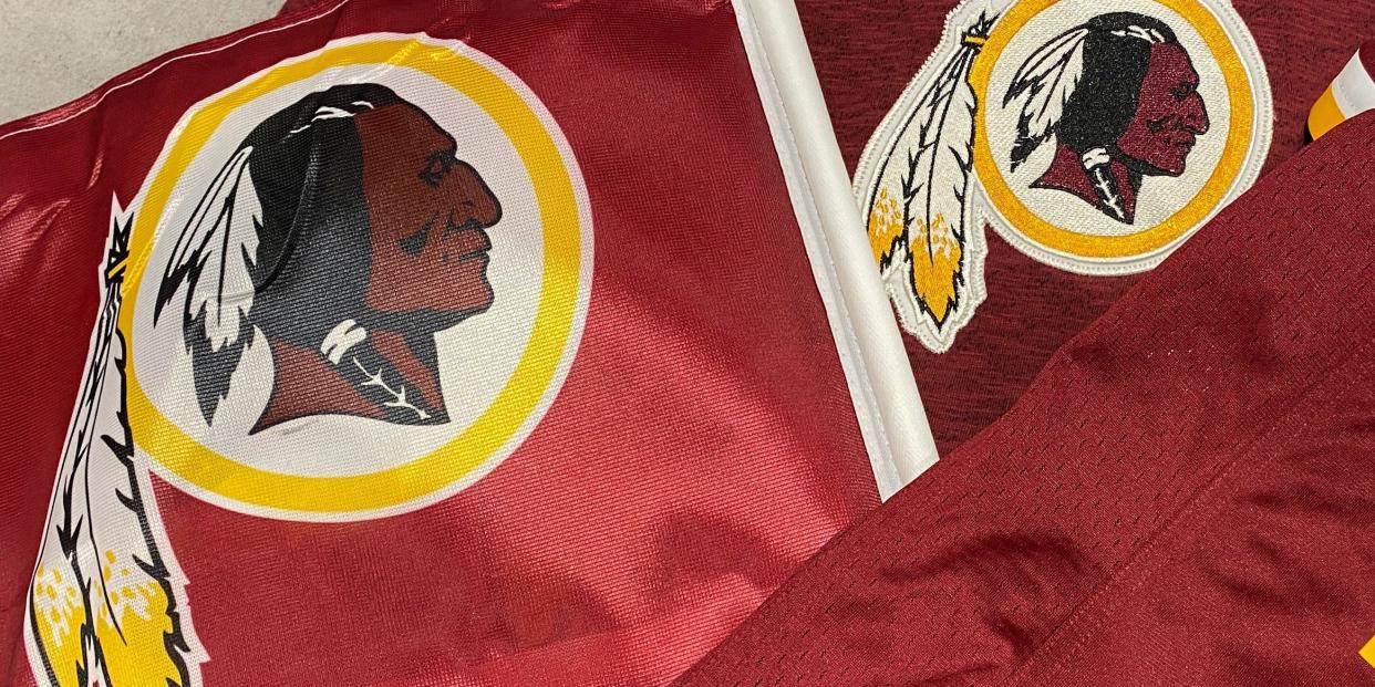 FILE PHOTO: Washington Redskins football shirts and a team flag on sale at a sporting goods store in Bailey's Crossroads, Virginia, U.S., June 24, 2020. REUTERS/Kevin Lamarque