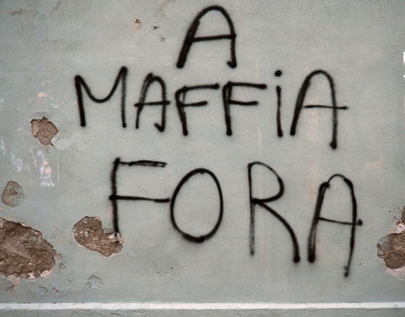 "Mafia out!" scrawled in Corsican on the wall of a house in the popular holiday destination that is also plagued by the mafia and organized crime. Rachel Boßmeyer/dpa