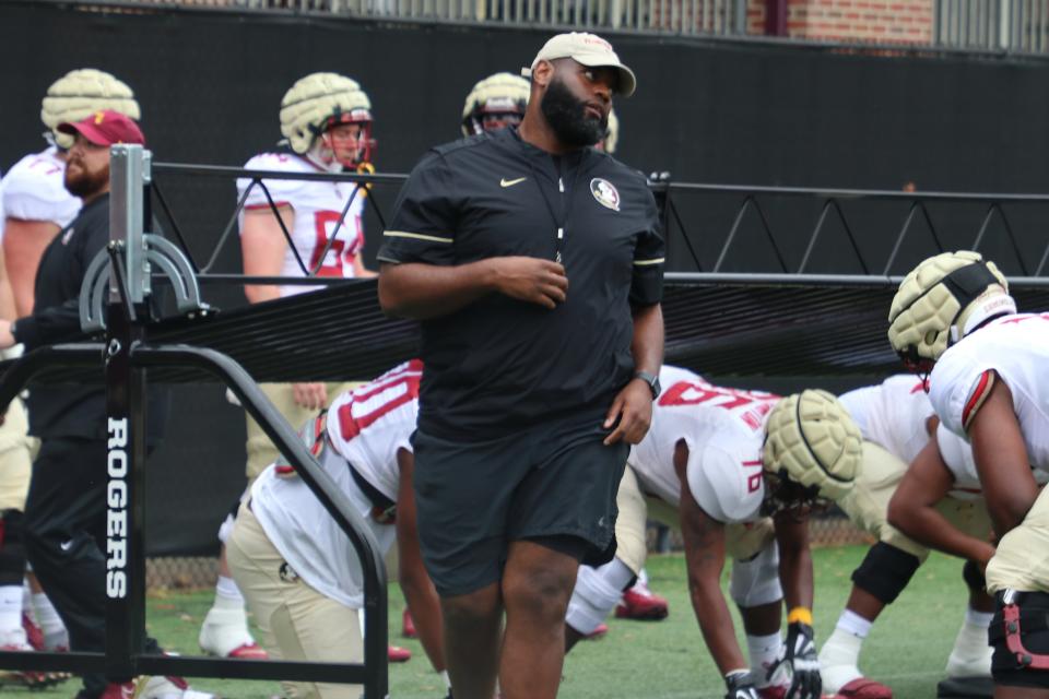 FSU offensive coordinator/offensive line coach Alex Atkins runs his players through a drill during the Seminoles' third spring football practice on Wednesday, March 9, 2022.