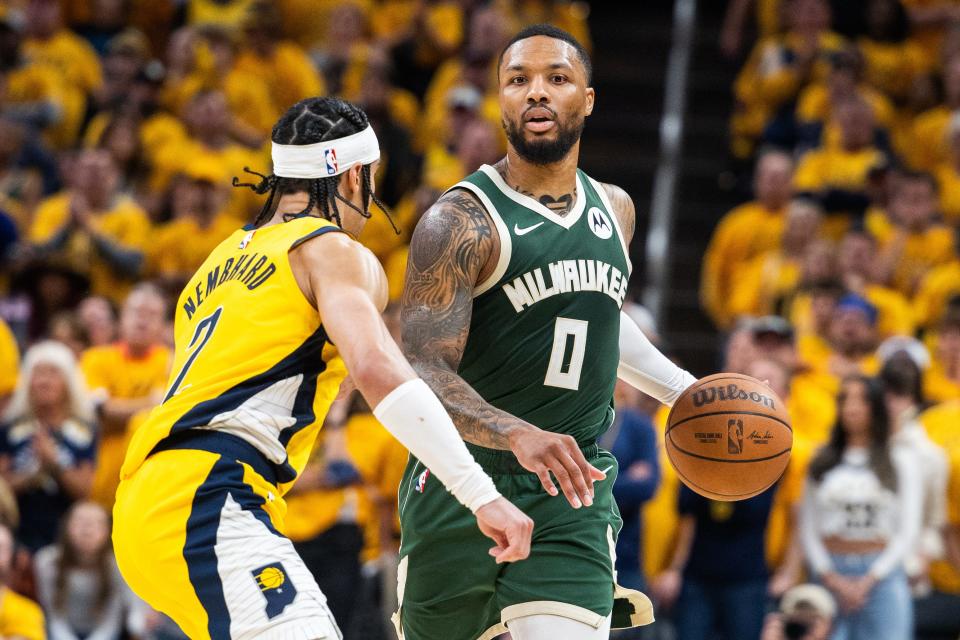 Apr 26, 2024; Indianapolis, Indiana, USA; Milwaukee Bucks guard Damian Lillard (0) dribbles the ball while Indiana Pacers guard Andrew Nembhard (2) defends during game three of the first round for the 2024 NBA playoffs at Gainbridge Fieldhouse. Mandatory Credit: Trevor Ruszkowski-USA TODAY Sports