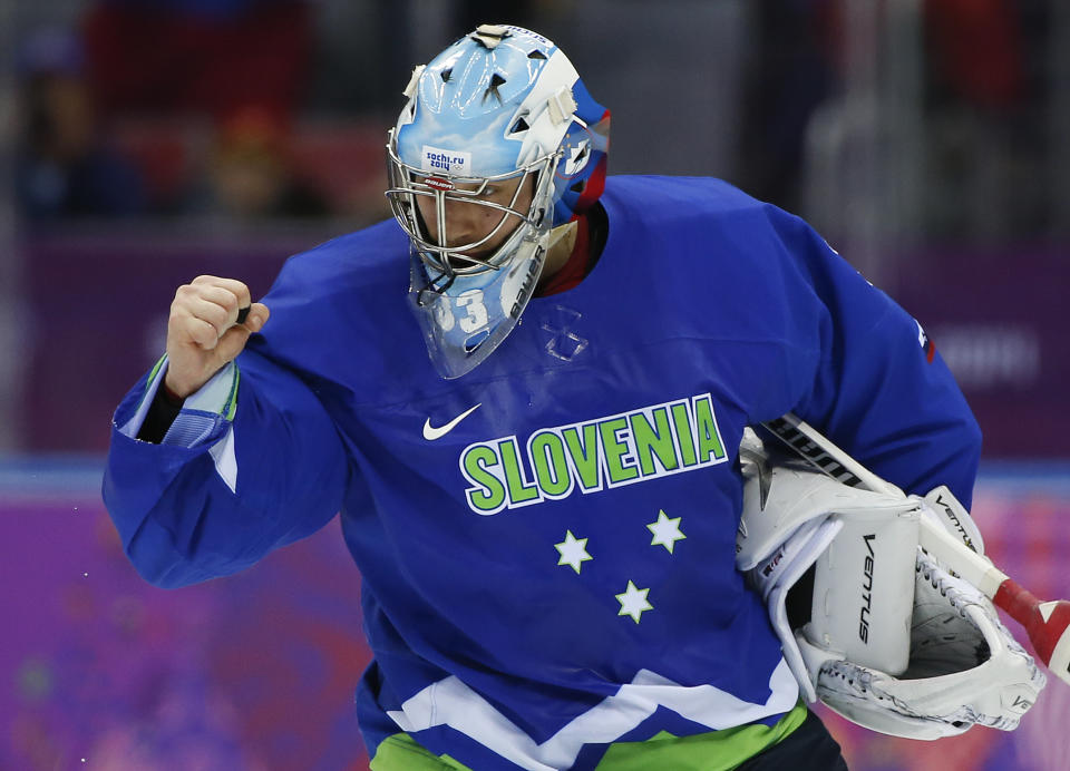Slovenia goaltender Robert Kristan pumps his fist after Slovenia beat Slovakia 3-1 in of a men's ice hockey game at the 2014 Winter Olympics, Saturday, Feb. 15, 2014, in Sochi, Russia. (AP Photo/Julio Cortez)