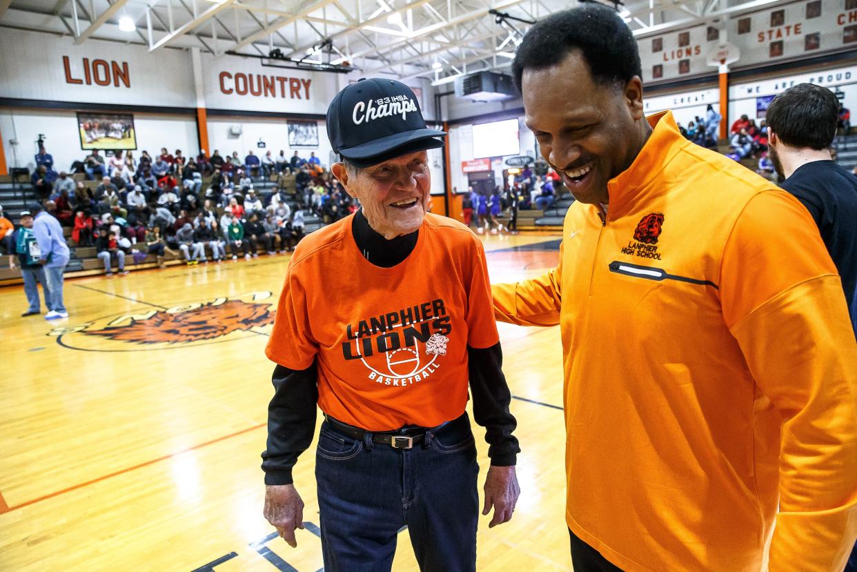 Former Lanphier athletic director and coach Arlyn Lober walks off the court with Principal Artie Doss after the 1983 Class AA state championship team was honored at Lober-Nika gymnasium, Saturday, Feb. 10, 2018, in Springfield.