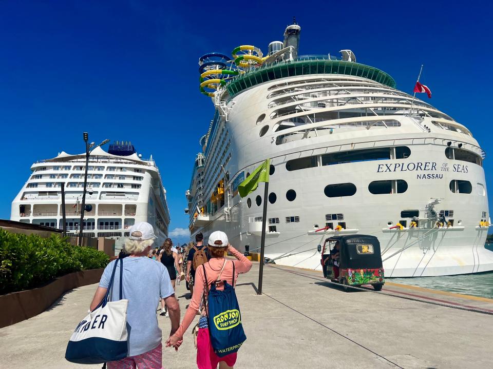 The Royal Caribbean and NCL ships side by side in port.