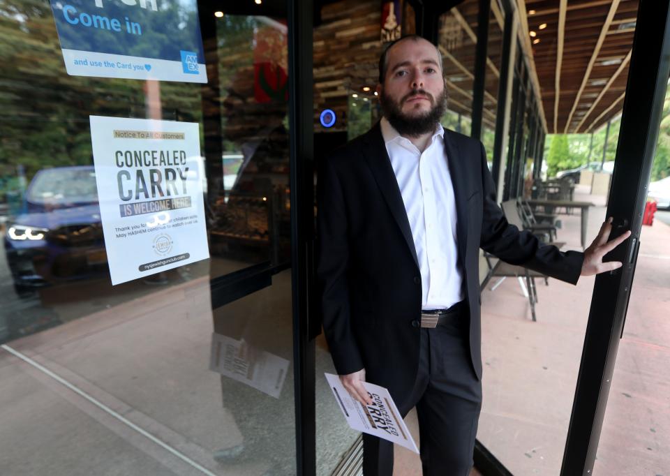 Tzvi Waldman, the head of the New York State Jewish Gun Club, is distributing signs to businesses in Rockland County informs patrons that they allow customers to bring guns into their stores. He was photographed at Molino Arms/Precision Gunsmiths, a gun store in Valley Cottage, New York.