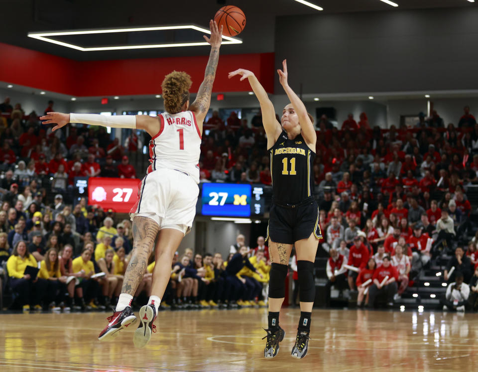 Michigan guard Greta Kampschroeder, right, shoots in front of Ohio State guard Rikki Harris during the first half of an NCAA college basketball game in Columbus, Ohio, Saturday, Dec. 31, 2022. (AP Photo/Paul Vernon)