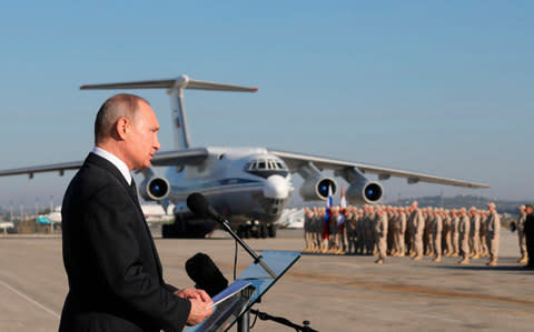 Vladimir Putin speaks to servicemen at Russia's airbase in Syria in December - Credit: Mikhail Klimentyev/Pool Photo via AP