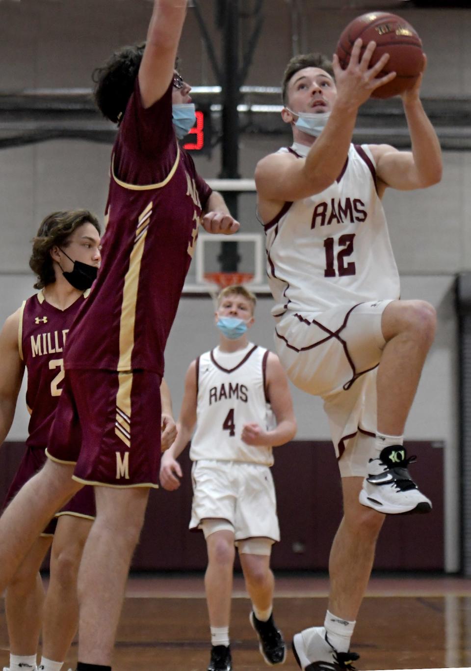 Northbridge's Ryan Boyce drives to the hoop on Millbury's Patrick Sheehan.