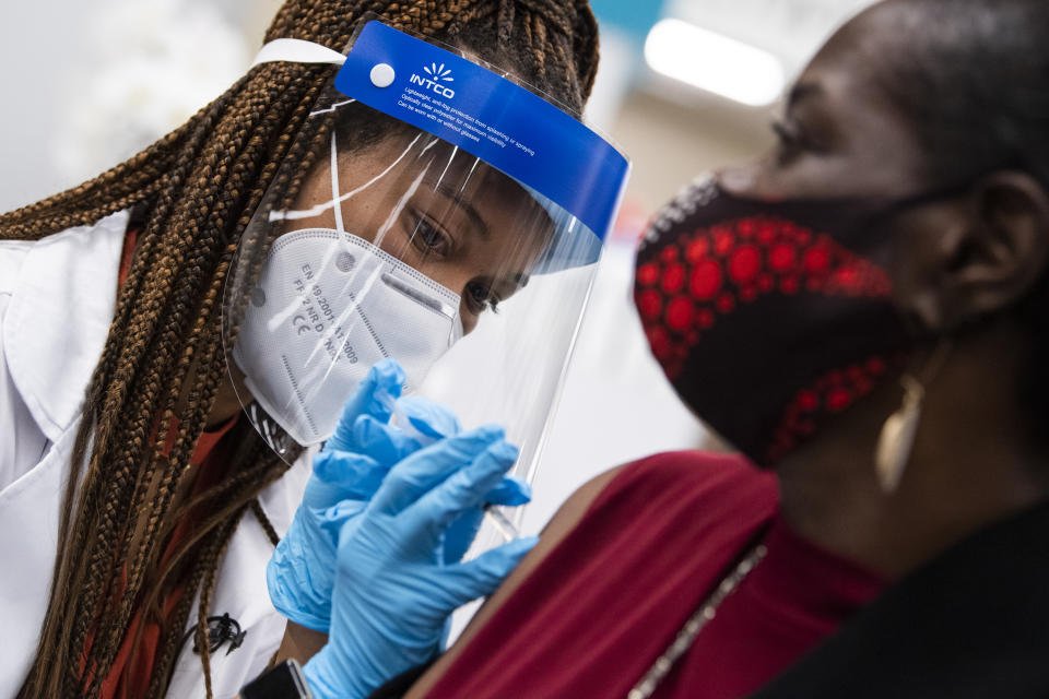 UNITED STATES - OCTOBER 4: Hattie Pierce, 75,  receives a Pfizer covid-19 vaccine booster shot from Dr. Tiffany Taliaferro at the Safeway on Capitol Hill in Washington, D.C., on Monday, October 4, 2021. (Photo By Tom Williams/CQ-Roll Call, Inc via Getty Images)