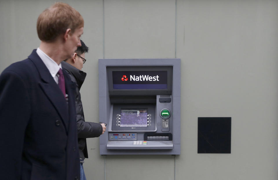 banks Two men walk past a cash machine outside a NatWest bank in London December 3, 2013. Many customers of Royal Bank of Scotland (RBS), NatWest and Ulster Bank experienced problems using their credit and debit cards for three hours on Monday. Some customers reported that problems had continued into Tuesday, local media reported.  REUTERS/Suzanne Plunkett (BRITAIN - Tags: BUSINESS POLITICS)