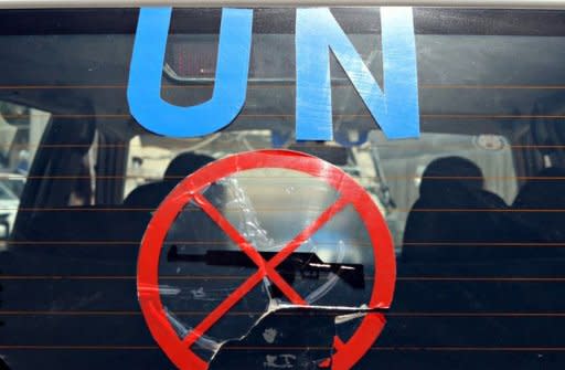 The United Nations monitors team leaves the UN headquarters in Damascus on a new tour of Syria's flashpoint areas on May 14