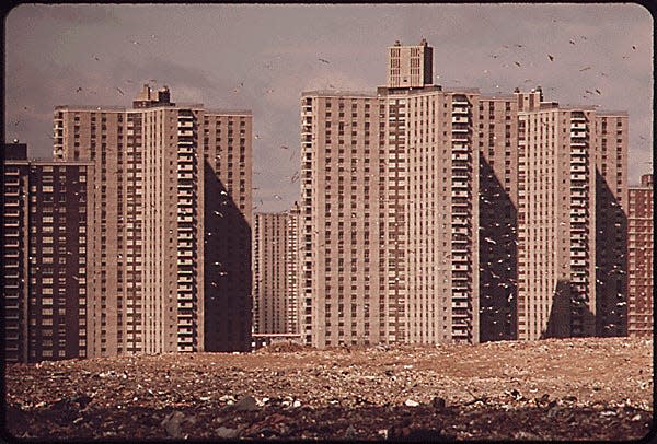 APARTMENTS OF "CO-OP CITY," A VAST HOUSING DEVELOPMENT IN THE BRONX, NOT FAR FROM PELHAM. THESE BUILDINGS STAND ON THE EDGE OF A LANDFILL DUMP, WHERE GARBAGE CONTINUES TO PILE UP ALTHOUGH THE AREA HAS ALREADY EXCEEDED ITS DUMPING CAPACITY