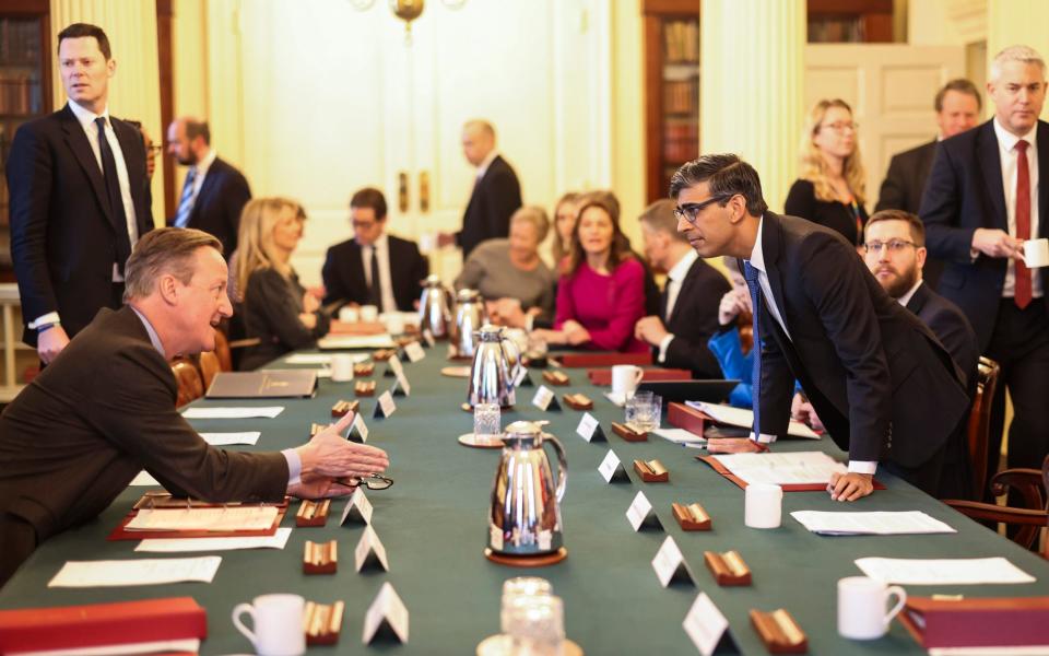 Rishi Sunak and Lord Cameron talk to each other during this morning's Cabinet meeting in 10 Downing Street