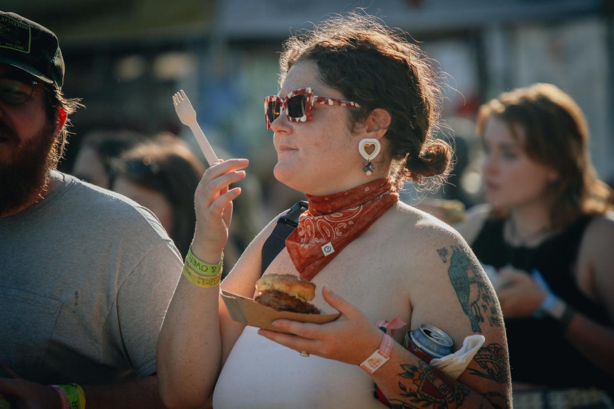 An attendee at Roots N Blues 2021 walks through the festival at Stephens Lake Park.