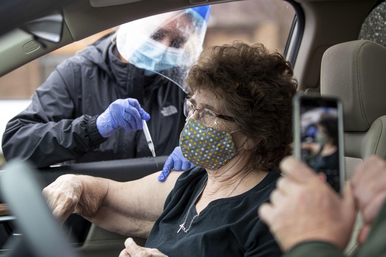 Myrtle Thompson receives a shot of the COVID-19 vaccine from Wayne County Health Department Administrator and Director of Nursing Tracey Sebastian, as the health department offers COVID-19 vaccines for anyone 80 years of age or older at a drive-thru site on Thursday, Dec. 31, 2020, in Wayne, W.Va.