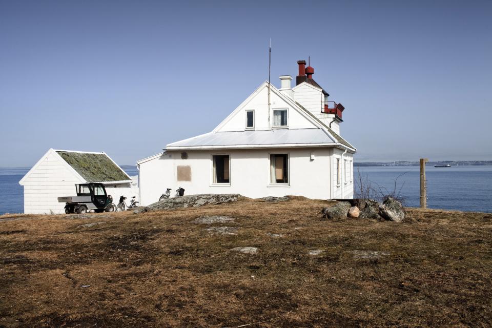 BASTOY ISLAND, HORTEN, NORWAY - APRIL 11:  The former Bastoy Island lighthouse now used by the prison workers as a holiday retreat is seen in on April 11, 2011 in Bastoy Island, Horten, Norway. Bastoy Prison is a minimum security prison located on Bastoy Island, Norway, about 75 kilometers (46 mi) south of Oslo. The facility is located on a 2.6 square kilometer (1 sq mi) island and hosts 115 inmates. Arne Kvernvik Nilsen, governor of the prison, leads a staff of about 70 prison employees. Of this staff, only five employees remain on the island overnight.  Once a prison colony for young boys, the facility now is trying to become 'the first eco-human prison in the world.' Inmates are housed in wooden cottages and work the prison farm. During their free time, inmates have access to horseback riding, fishing, tennis, and cross-country skiing. (Photo by Marco Di Lauro/Reportage by Getty Images)