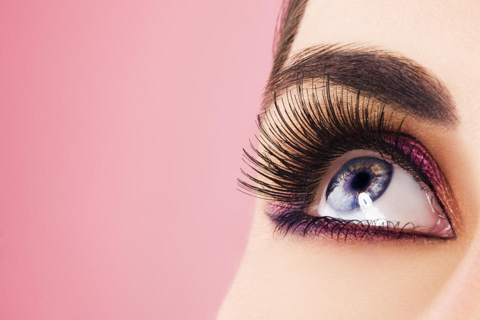 Woman eye with long eyelashes. Space for text.