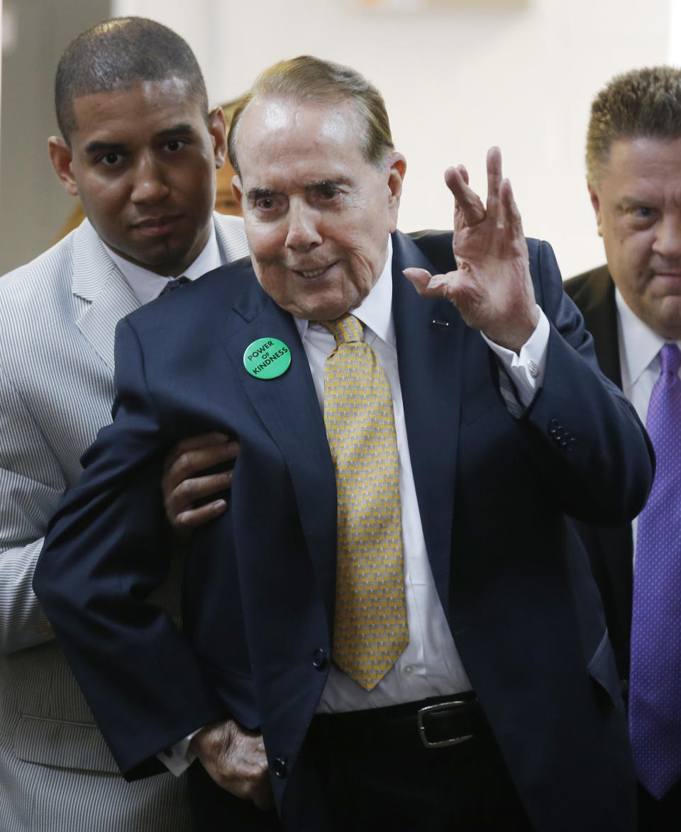 Former Sen. Bob Dole, R-Kan., waves to a crowd gathered at Johnson County Republican Headquarters in Overland Park, Kan., Monday, April 21, 2014. (AP Photo/Orlin Wagner)