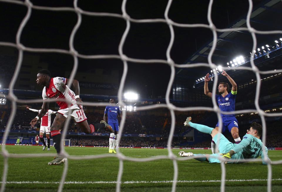 Ajax's Quincy Promes, left, celebrates after scoring his side's second goal during the Champions League, group H, soccer match between Chelsea and Ajax, at Stamford Bridge in London, Tuesday, Nov. 5, 2019. (AP Photo/Ian Walton)