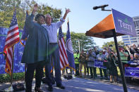 Voting rights activist Stacey Abrams, left, waves to the crowd with Democratic gubernatorial candidate, former Virginia Gov. Terry McAuliffe, right, during a rally in Norfolk, Va., Sunday, Oct. 17, 2021. Abrams was in town to encourage voters to vote for the Democratic gubernatorial candidate in the November election. (AP Photo/Steve Helber)