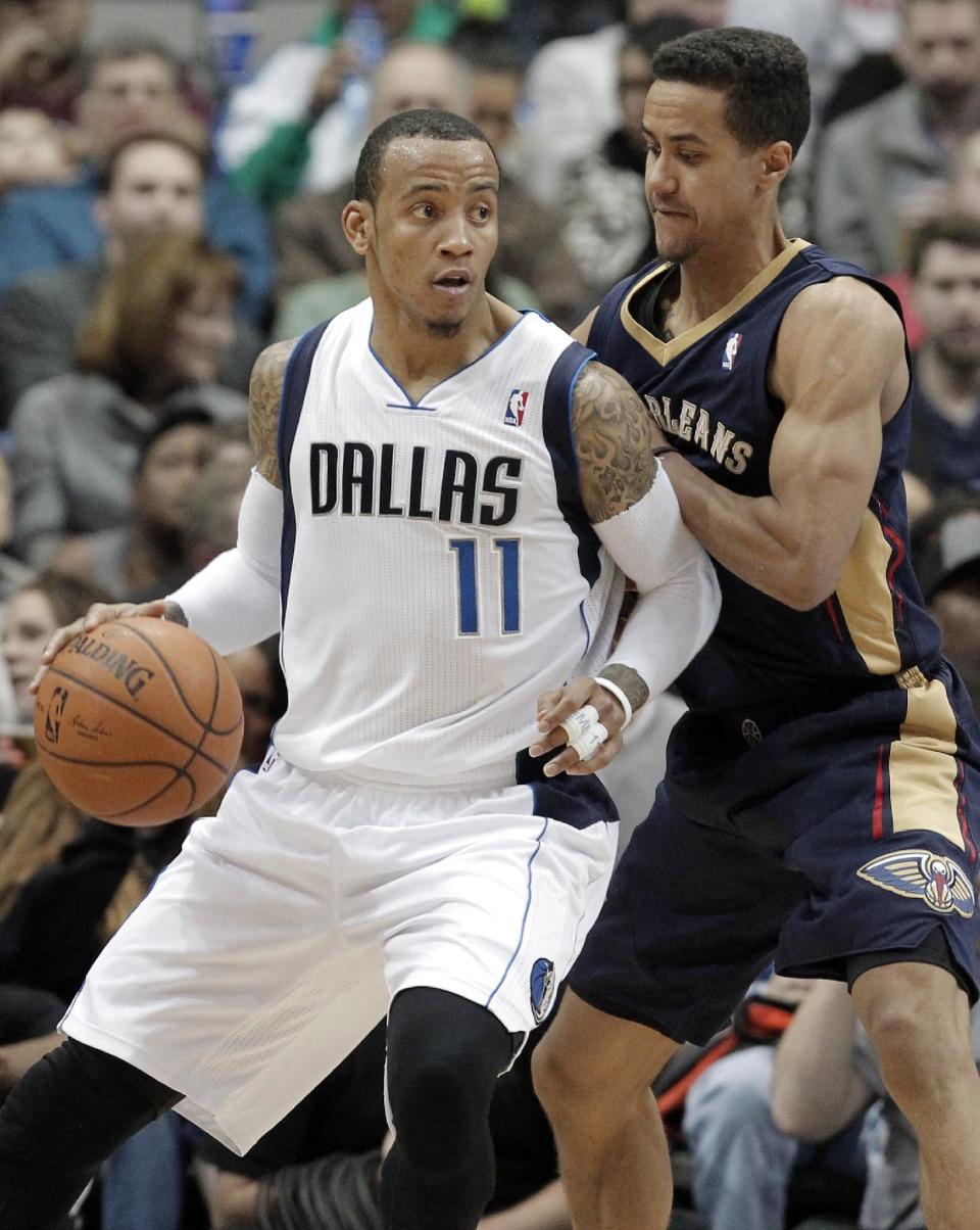 Dallas Mavericks' guard Monta Ellis (11) battles New Orleans Pelicans' Brian Roberts (22) for space during the second half of an NBA basketball game on Wednesday, Feb. 26, 2014, in Dallas. Dallas won 108-89. (AP Photo/Brandon Wade)