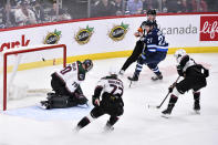 Winnipeg Jets' Nikolaj Ehlers (27) scores on Arizona Coyotes' goaltender Karel Vejmelka (70) during the first period of an NHL hockey game, Tuesday, March 21, 2023 in Winnipeg, Manitoba. (Fred Greenslade/The Canadian Press via AP)