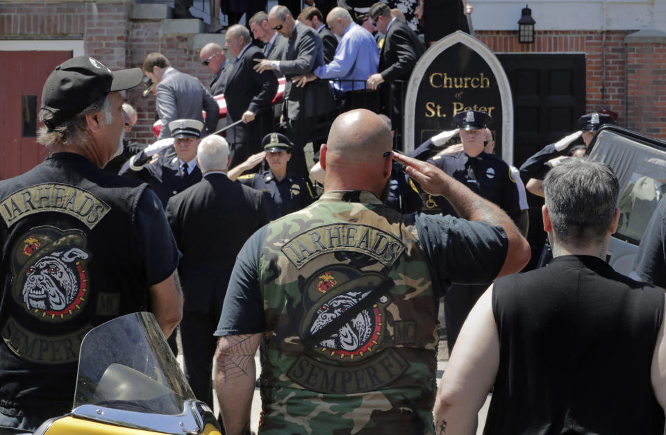 Members of the Jarheads Motorcycle Club and a police honor guard salute as the casket of Michael Ferazzi is loaded into a hearse outside St. Peter's Catholic Church in Plymouth, Mass., Friday, June 28, 2019. Ferazzi, a motorcyclist and retired police officer, was killed in a fiery crash that claimed the lives of seven people riding with the Jarheads Motorcycle Club in New Hampshire. (AP Photo/Charles Krupa)