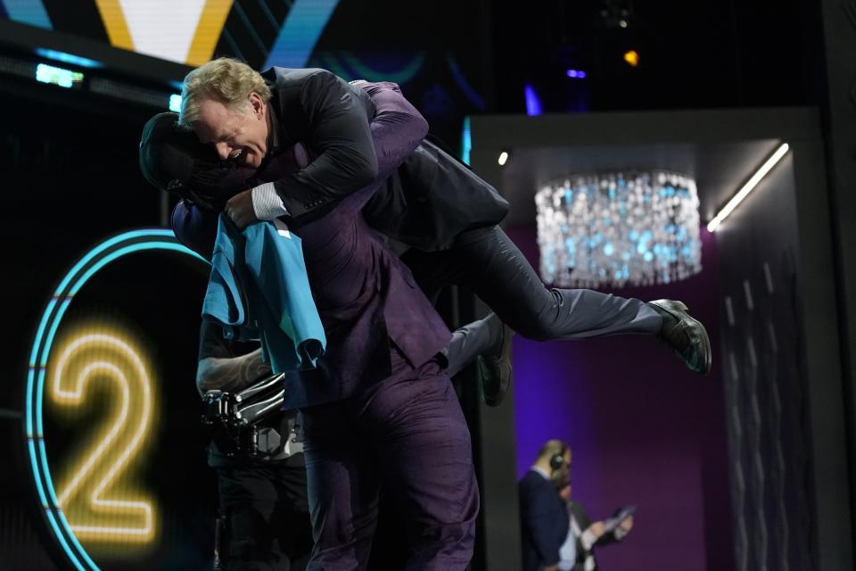 Utah linebacker Devin Lloyd lifts NFL Commissioner Roger Goodell after being chosen by the Jacksonville Jaguars with the 27th pick of the NFL football draft Thursday, April 28, 2022, in Las Vegas. (AP Photo/John Locher)