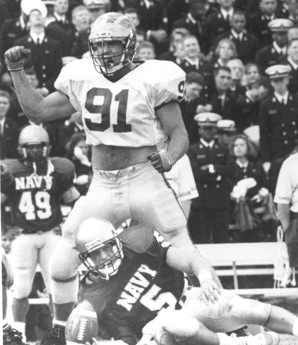 Delaware defensive lineman Matt Morrill celebrates taking down Navy quarterback Jason Van Matre in the Blue Hens' 1992 win.