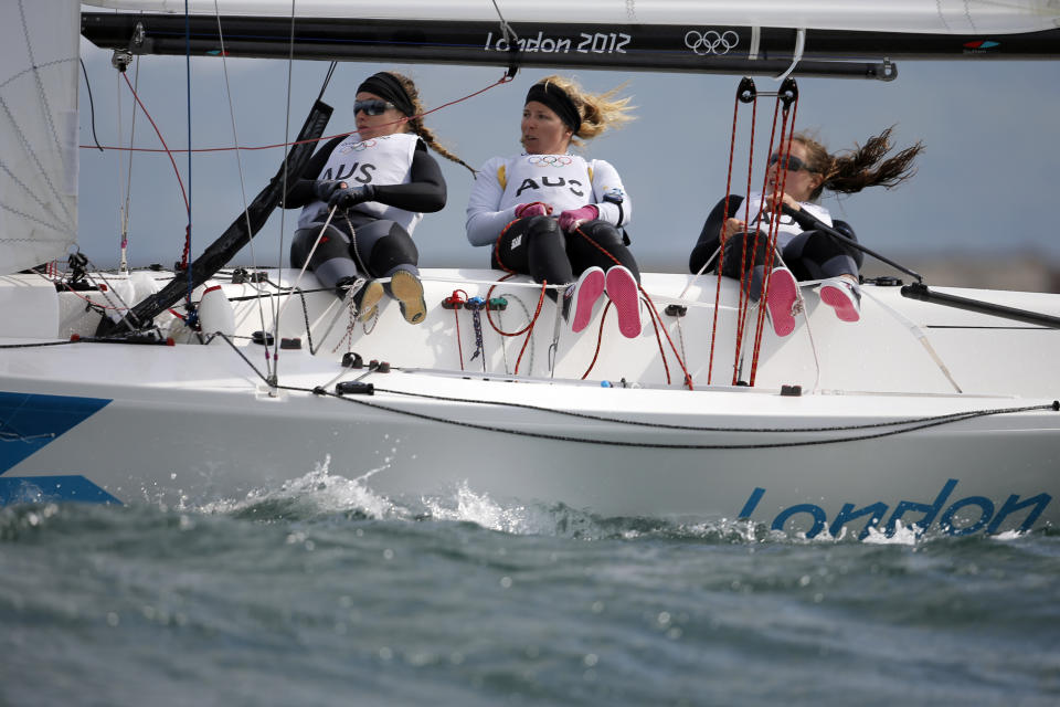 FILE - In this Aug. 11, 2012, file photo, Australia's Elliot 6m crew Lucinda Whitty, left, Nina Curtis and Olivia Price compete during the medal race at the Summer Olympics, in Weymouth and Portland, England. Curtis has been picked to join the defending champion Australian SailGP team for the rest of the season as part of a developmental program designed to bring women into the global league. Curtis, who won a silver medal at the 2012 London Olympics and sailed with Team Brunel on the final five legs of the 2017-18 Volvo Ocean Race, beat out Lisa Darmanin in a training camp during the season-opening regatta in Bermuda two weeks ago. (AP Photo/Francois Mori, File)