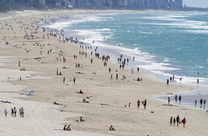 Crowds are seen enjoying beach conditions on the Gold Coast.