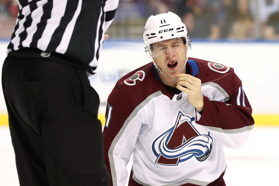 Colorado Avalanche left wing Matt Calvert reacts after being injured during a play in the first period of the team's NHL hockey game against the Florida Panthers, Friday, Oct. 18, 2019 in Sunrise, Fla. (AP Photo/Wilfredo Lee)