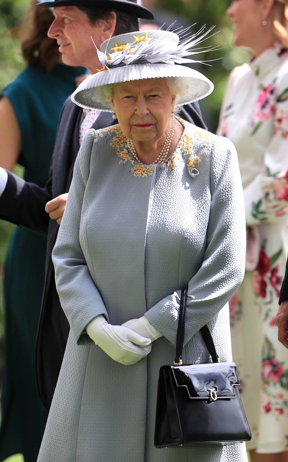 The Queen wearing the same ensemble a Royal Ascot in 2019 - PA