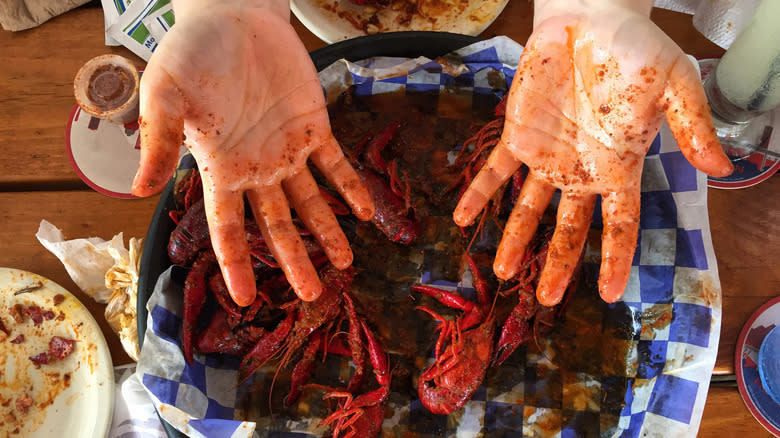 messy hands with crawfish