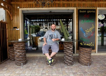 Barista Salem al-Warfali, 31, who works at a coffee shop, poses for a photograph in Tripoli, Libya, May 14, 2017. REUTERS/Ismail Zitouny