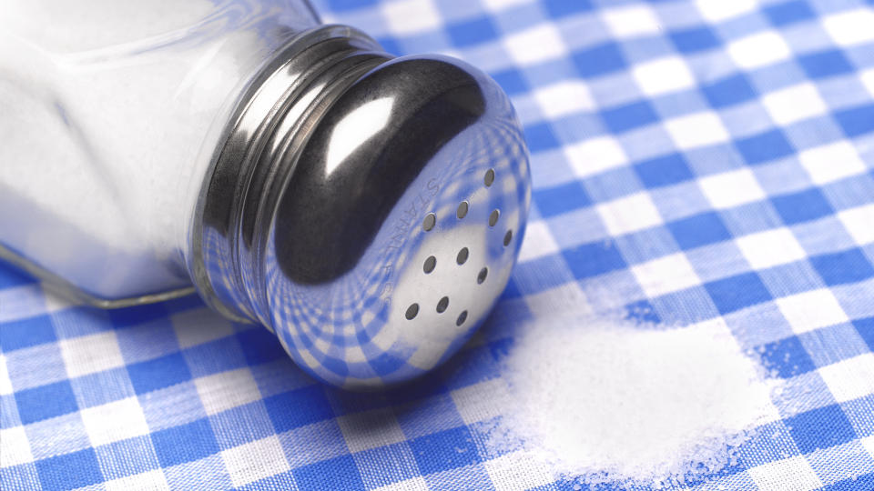 Salt spilling on to table cloth