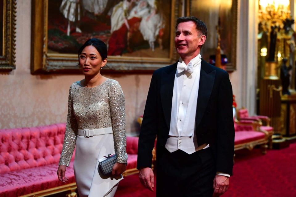 Foreign Secretary Jeremy Hunt and his wife, Lucia, arriving at Buckingham Palace in November 2020 (PA)