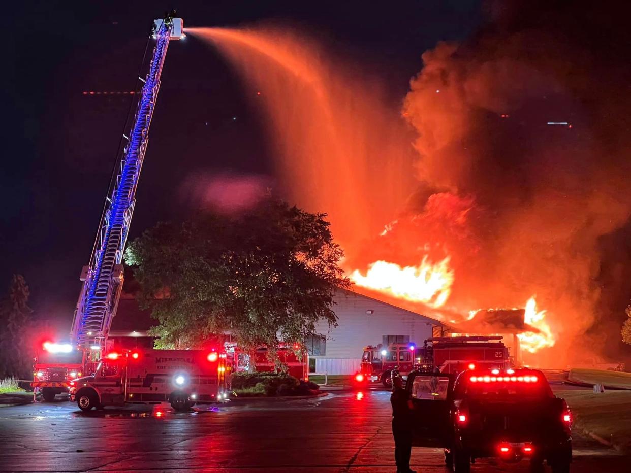 Firefighters battle an early-morning fire Aug. 26, 2024, at Juday Creek Golf Course's clubhouse in Granger.