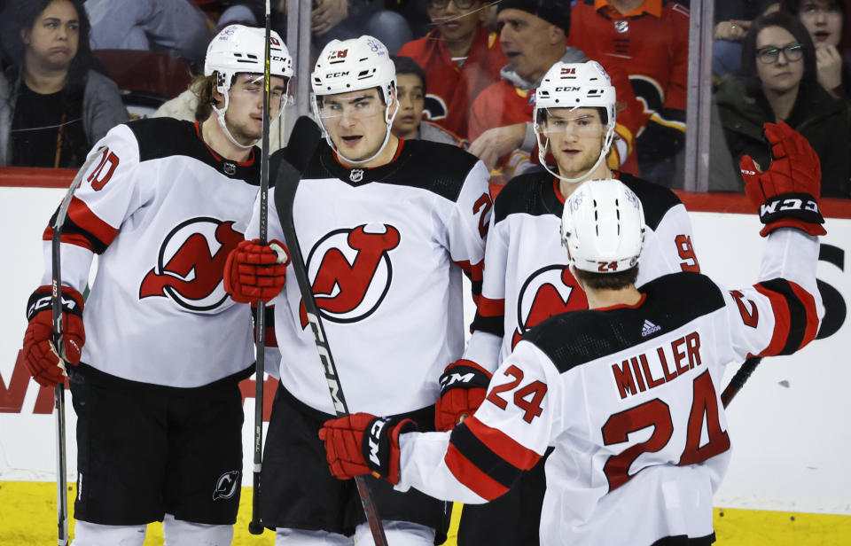 New Jersey Devils forward Timo Meier (28) celebrates his goal against the Calgary Flames with teammates during the third period of an NHL hockey game Saturday, Dec. 9, 2023, in Calgary, Alberta. (Jeff McIntosh/The Canadian Press via AP)