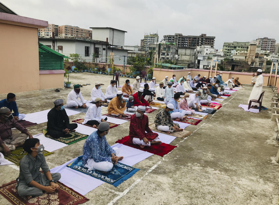 Bangladeshi Muslims offer Eid al-Fitr prayers in Dhaka, Monday, May 25, 2020. The holiday of Eid al-Fitr, the end of the fasting month of Ramadan, a usually joyous three-day celebration has been significantly toned down as coronavirus cases soar. (AP Photo/Al-emrun Garjon)