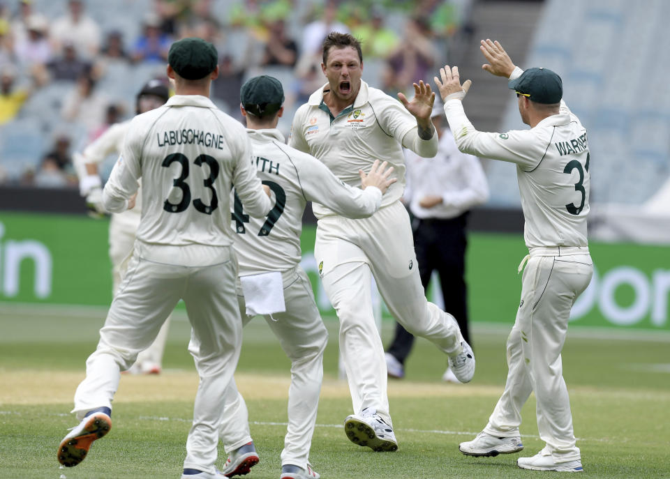 Australia's James Pattinson, center, celebrates with teammates after capturing the wicket of New Zealand's BJ Watling during a cricket test match in Melbourne, Australia, Saturday, Dec. 28, 2019. (AP Photo/Andy Brownbill)