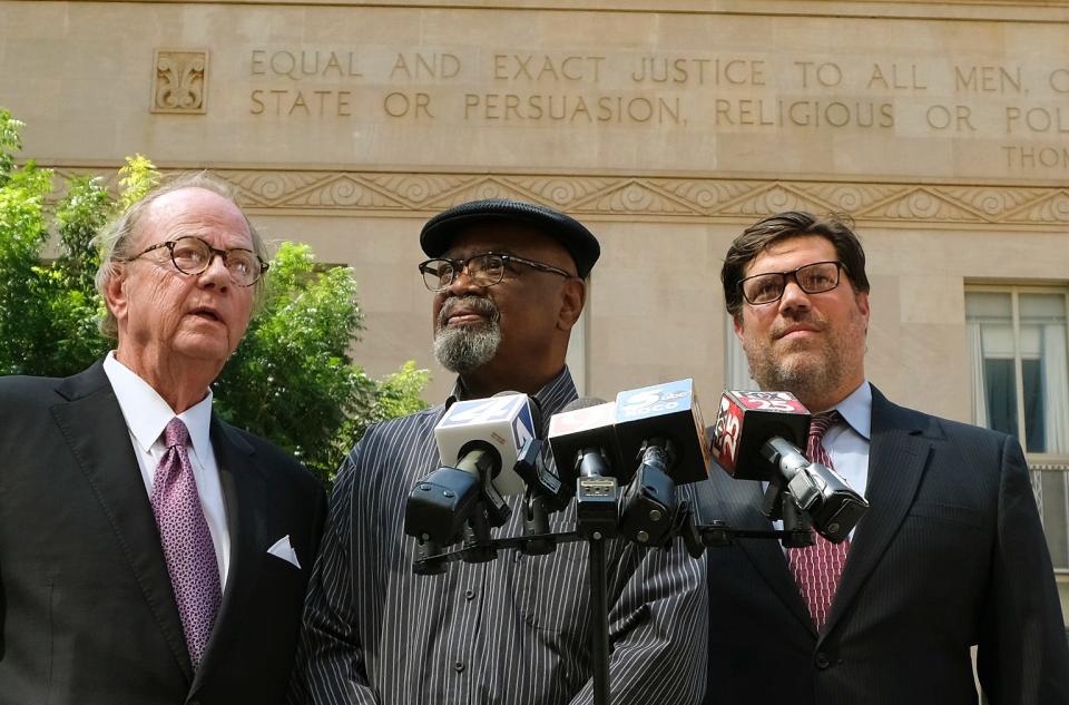 Pictured from left, John Coyle, Glynn Simmons and Joe Norwood hold a news conference Wednesday outside the Oklahoma County Courthouse. A murder case against Simmons was officially dismissed on Tuesday.