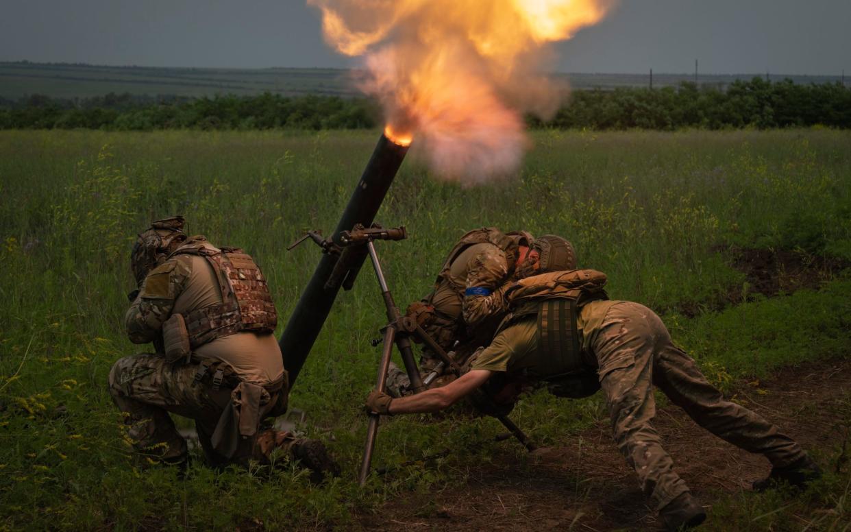 Ukrainian soldiers fire toward Russian positions on the frontline in the Zaporizhzhia region of Ukraine