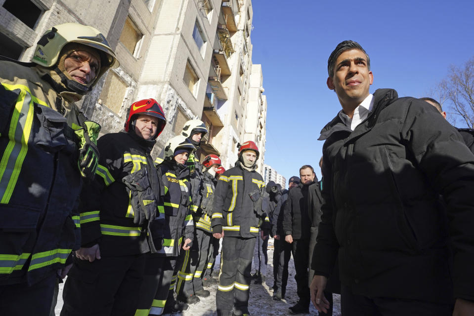 Prime Minister Rishi Sunak talks to firefighters in Kyiv, Ukraine, ahead of meeting with President Volodymyr Zelenskyy to announce a major new package of military aid to Ukraine, Friday, Jan. 12, 2024. (Stefan Rousseau/Pool via AP)