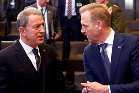 FILE PHOTO: Turkey's Defence Minister Akar talks to acting U.S. Secretary of Defense Shanahan during a NATO defence ministers meeting in Brussels
