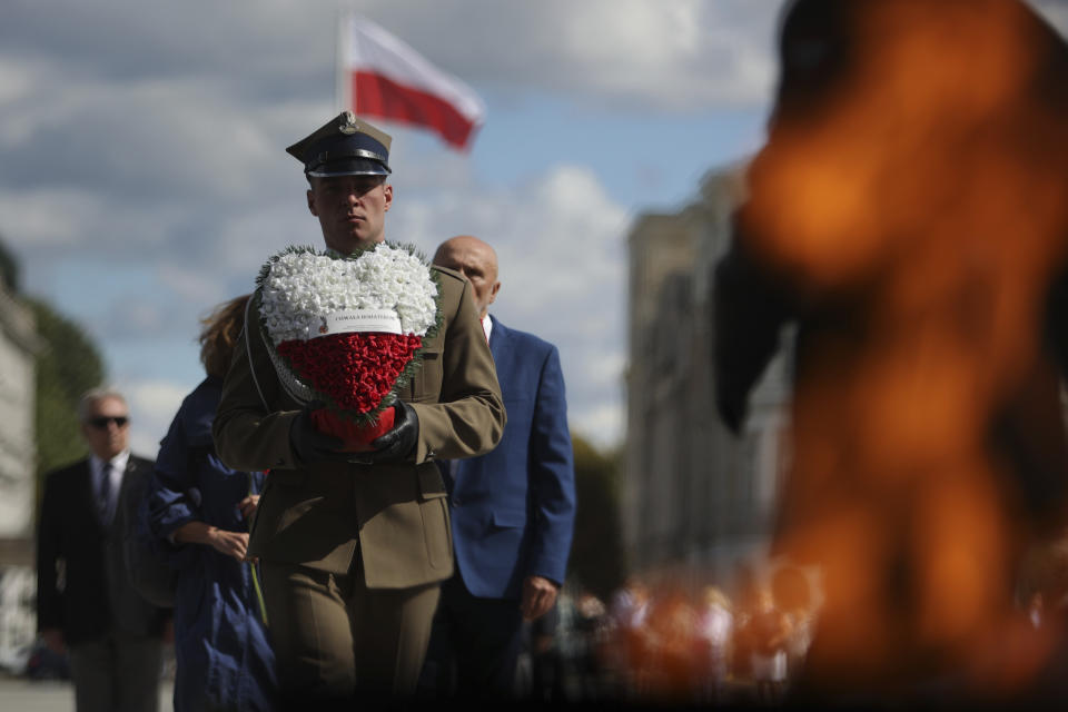 A Polish soldier holds a wreath while attending a ceremony marking national observances of the anniversary of World War II in Warsaw, Poland, Sept. 1, 2022. World War II began on Sept. 1, 1939, with Nazi Germany's bombing and invading Poland, for more than five years of brutal occupation. (AP Photo/Michal Dyjuk)