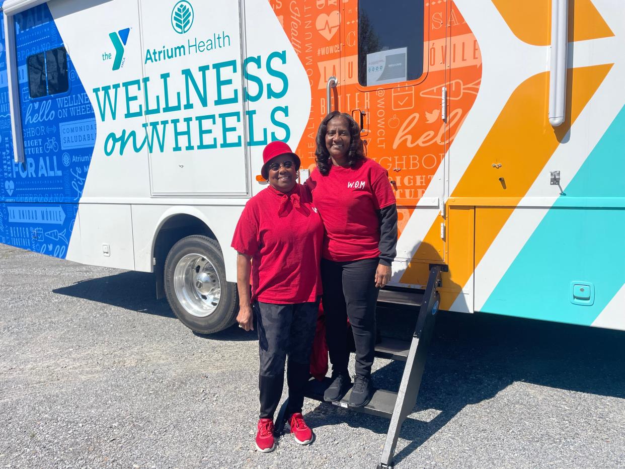 Rev. Frances Webber, director of Washington Outreach Ministry, and Vanita Roberts, assistant director, show off the new mobile primary care bus available to the community each Wednesday.
